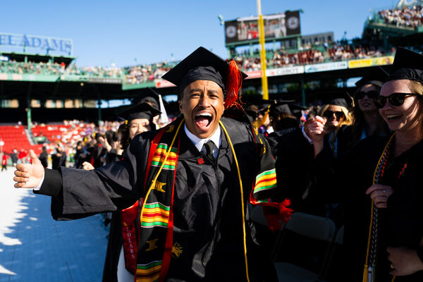 Northeastern Graduate cheering at Fenway Park's commencement